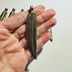 Eight Vintage Feather Pendants in Silver